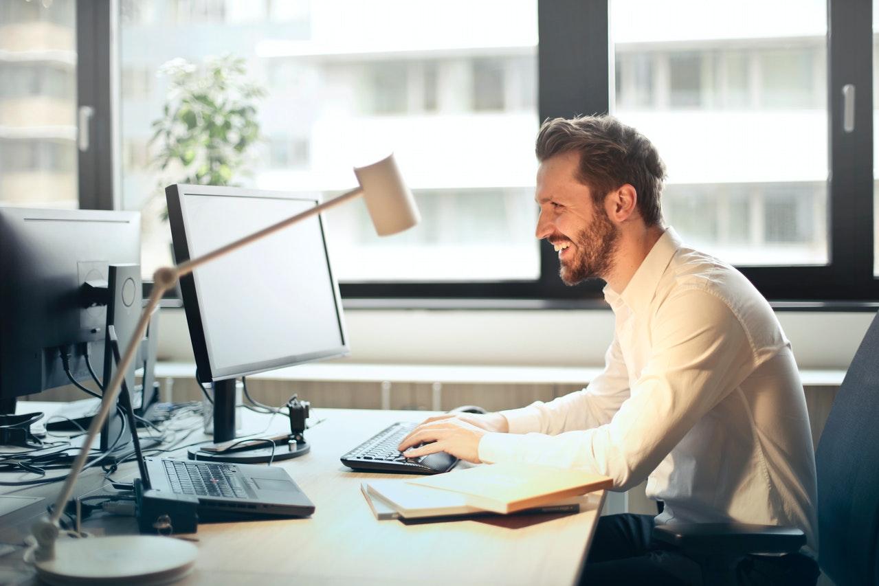 man typing at computer